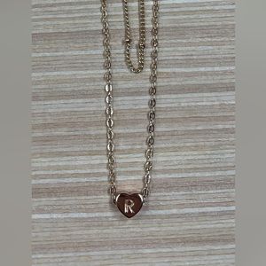 Doubled heart shaped “R” necklace.